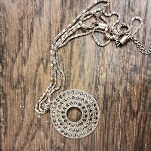 Silver tone necklace with rhinestone charm